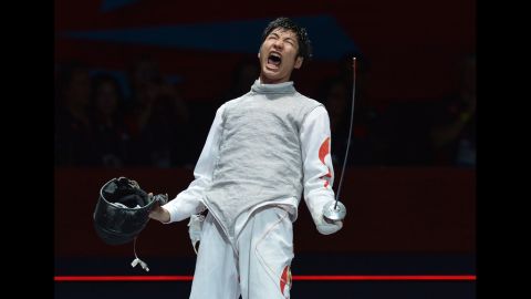 Chinese fencer Lei Sheng celebrates his victory over Italy's Andrea Baldini at the end of their men's foil semifinal bout.