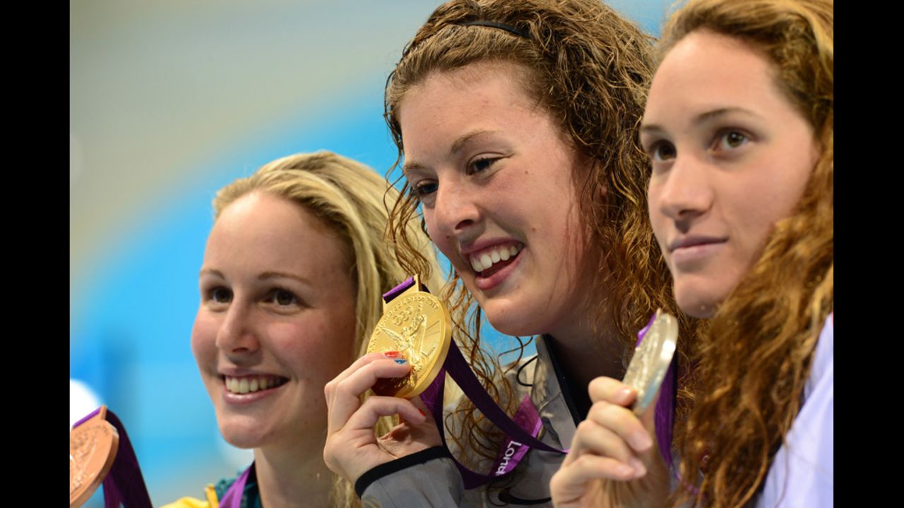 Gold medalist  Allison Schmitt, center, silver medalist Camille Muffat of France, right, and bronze medalist Bronte Barratt of Australia smile on the podium after the women's 200-meter freestyle final on Tuesday. 