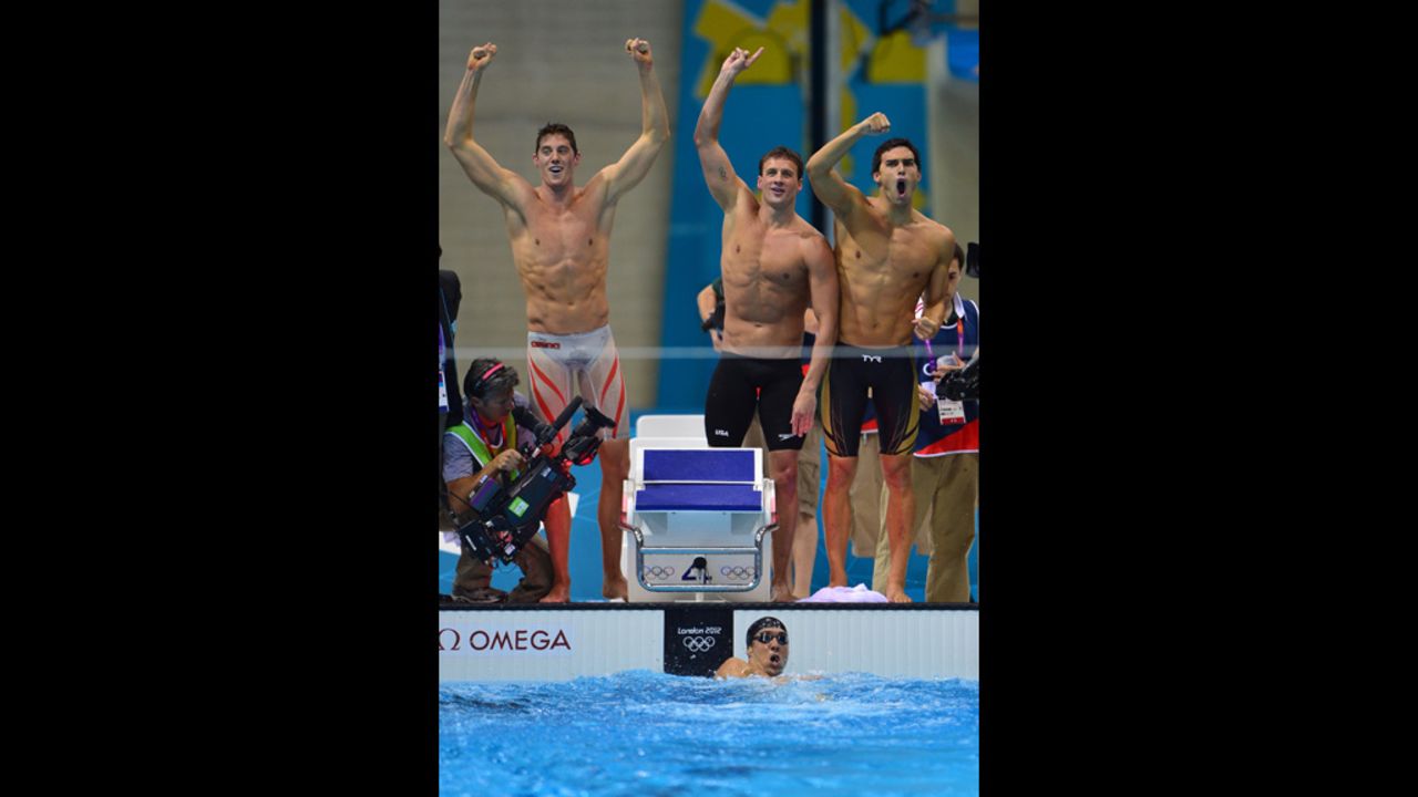 U.S. swimmers Ryan Lochte, center, Conor Dwyer, left, Ricky Berens, right, and Michael Phelps, in the water, react after their win.