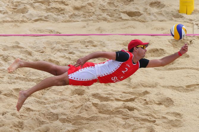 Jefferson Bellaguarda of Switzerland dives for a shot during the men's beach volleyball preliminary match between Brazil and Switzerland on Tuesday.