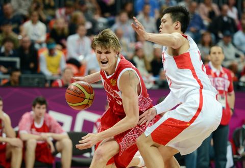 Chinese forward Zhou Peng, right, guards Russian forward Andrei Kirilenko during the men's preliminary round basketball game Tuesday.