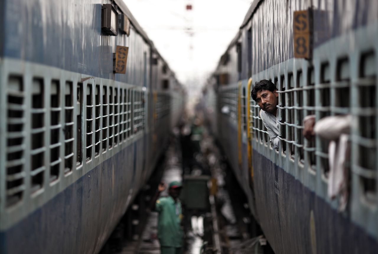 A passenger peers out the window of a train as he waits for electricity to be restored at a railway station in New Delhi on Tuesday. India suffered its second huge power failure in two days on Tuesday, depriving as much as half of the vast and populous country of electricity and disrupting transport networks.