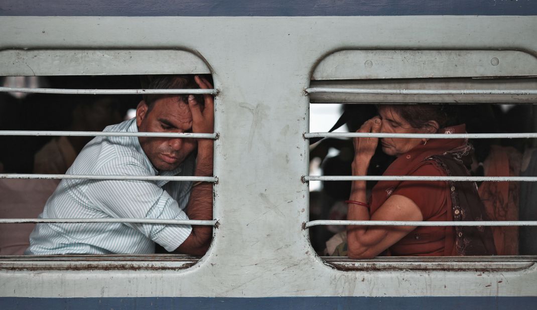 Passengers sit on a train with no electricity as power failures halt transportation across the country Tuesday. 