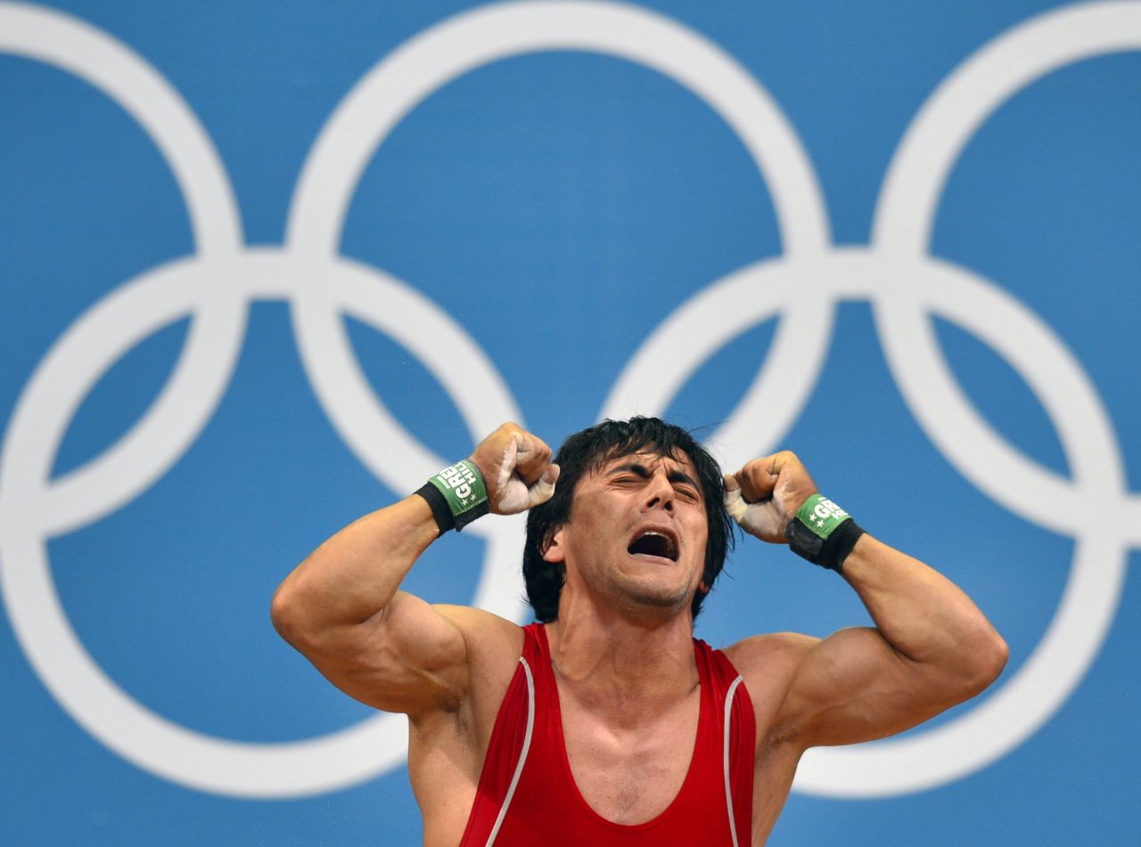 Azerbaijan's Sardar Hasanov reacts after failing a lift in the men's weightlifting 69-kilogram group B event Tuesday.