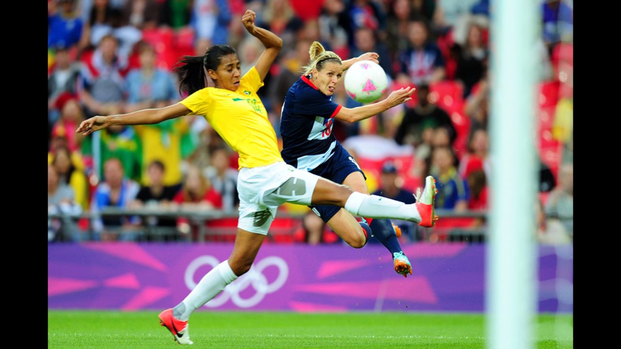Kelly Smith of Great Britain shoots a goal under pressure from Bruna of Brazil during the women's first-round football match.