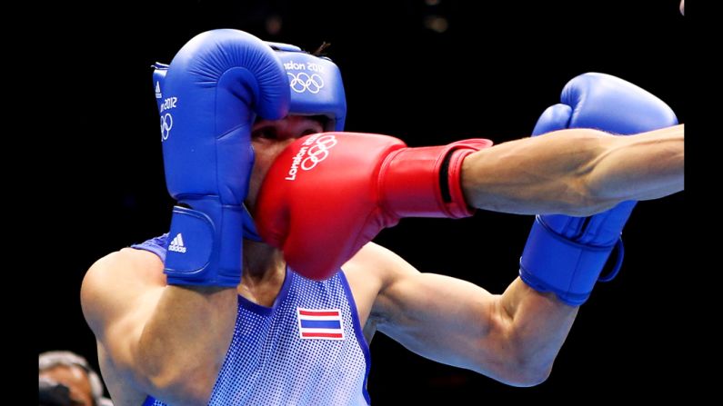 Kaeo Pongprayoon of Thailand boxes Mohamed Flissi of Algeria.