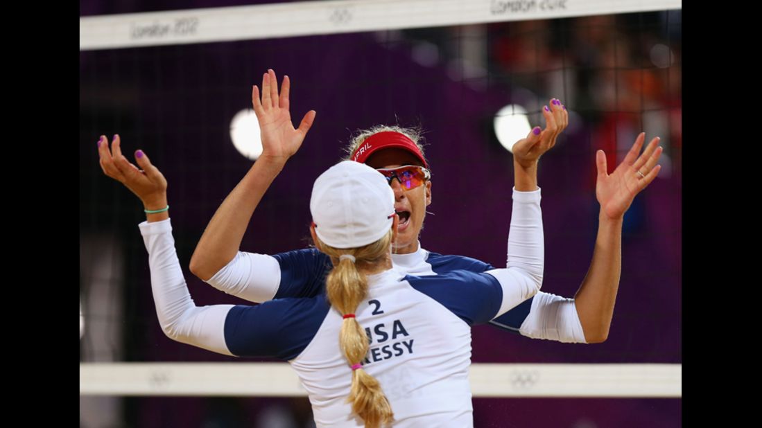 April Ross and Jennifer Kessy of the United States celebrate a point during the women's beach volleyball preliminary match against the Netherlands.