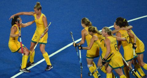 Australian players celebrate a goal during the preliminary round women's field hockey match against Germany.