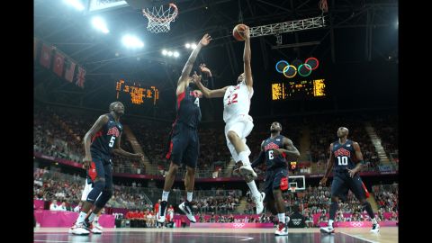 Makram Ben Romdhane of Tunisia dunks over Tyson Chandler of the United States during a preliminary match.
