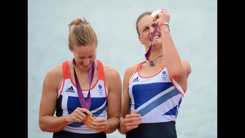 Rowers Helen Glover, left, and Heather Stanning of Great Britain celebrate with their gold medals during the medal ceremony.