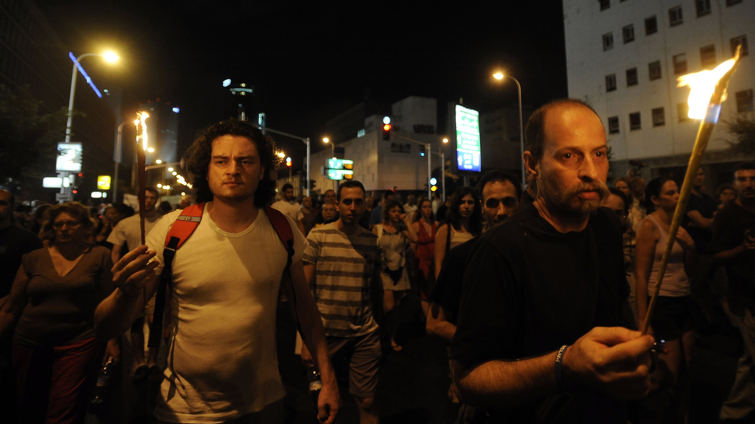 Israelis attend a demonstration in Tel Aviv on July 21 in memory of  the first protester who set himself alight on July 14.
