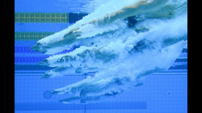 Swimmers dive in for heat 5 of the men's 200-meter individual medley.
