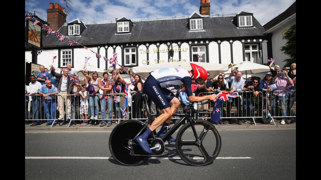 Bradley Wiggins of Great Britain cycles past a pub in Esher during a road cycling event.