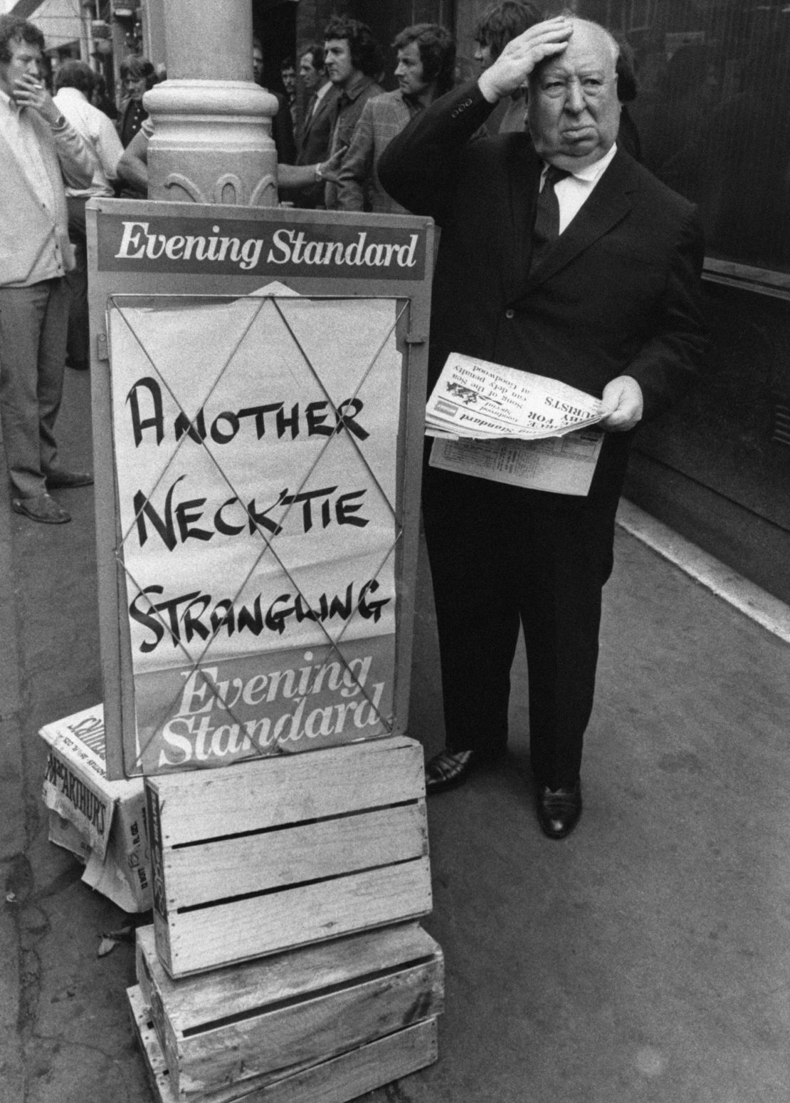 Alfred Hitchcock buys a copy of the Evening Standard with a chilling headline.