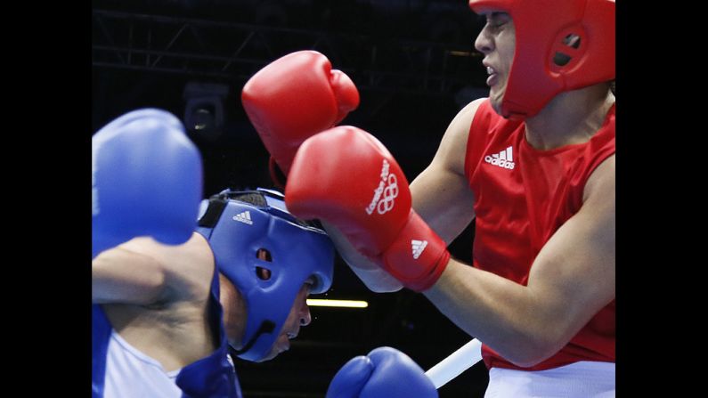 Yamil Peralta Jara of Argentina, right, defends against Chouaib Bouloudinats of Algeria during their heavyweight boxing match.
