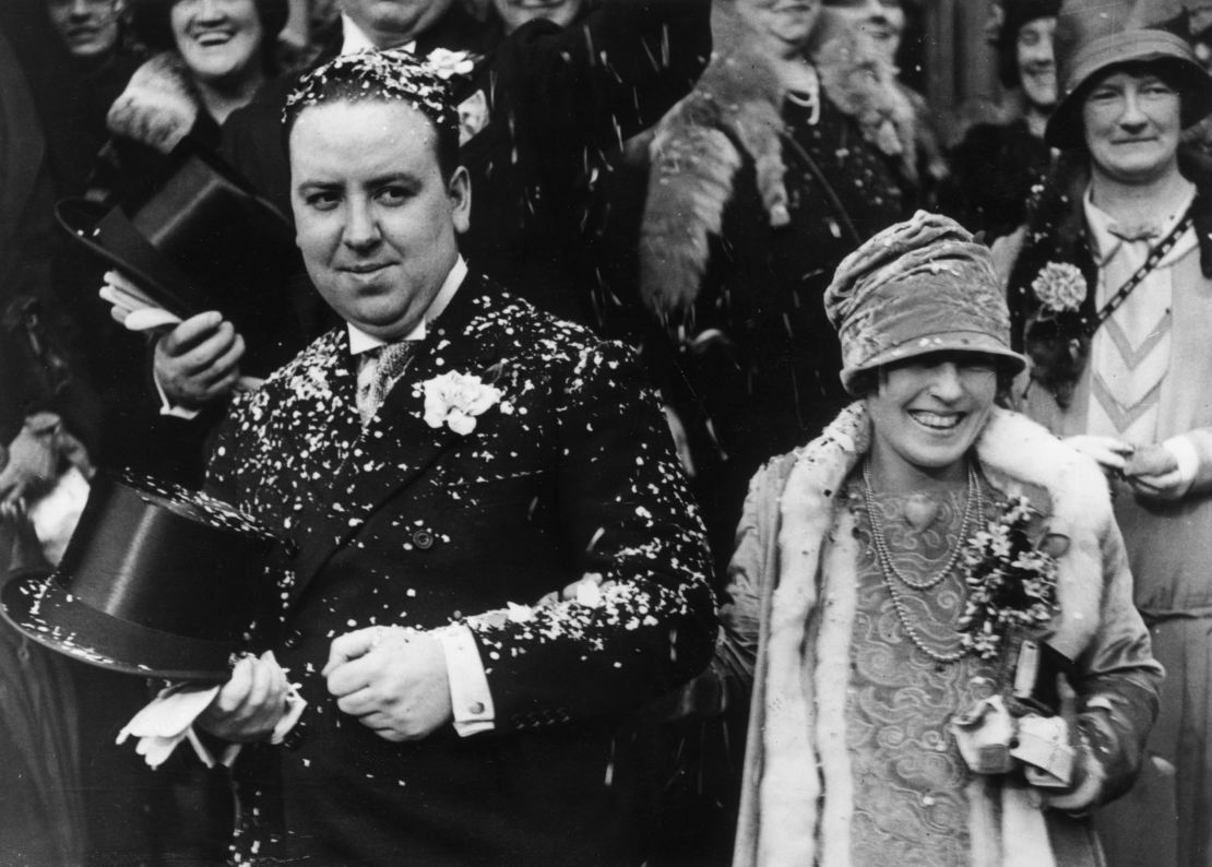 Alfred Hitchcock and Alma Reville are showered with confetti after their wedding.