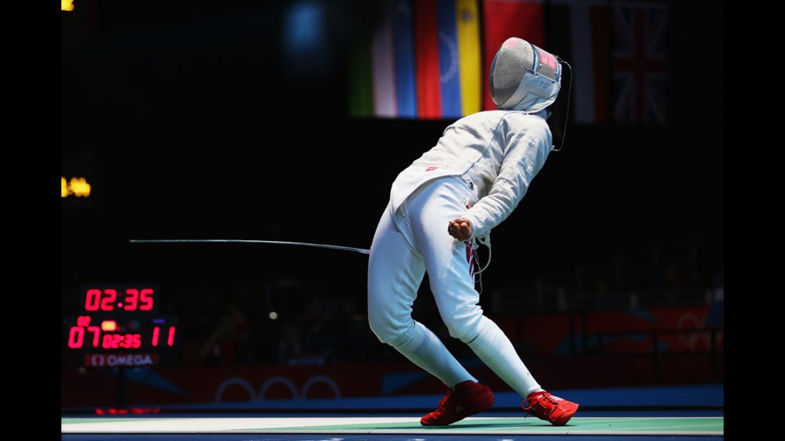 Amira Ben Chaabane of Tunisia celebrates a point against Xiaodong Chen of China in the women's saber individual round 32 match.