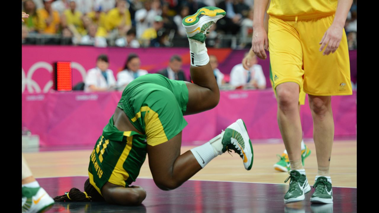 Brazilian center Clarissa Santos falls during the women's preliminary basketball match against Australia.