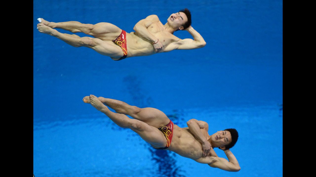 China's Qin Kai and Luo Yutong compete in the men's synchronized 3-meter springboard diving event.