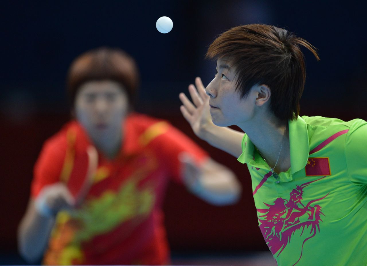 China's Ding Ning, right, serves during her table tennis women's gold medal singles match against compatriot Li Xiaoxia.
