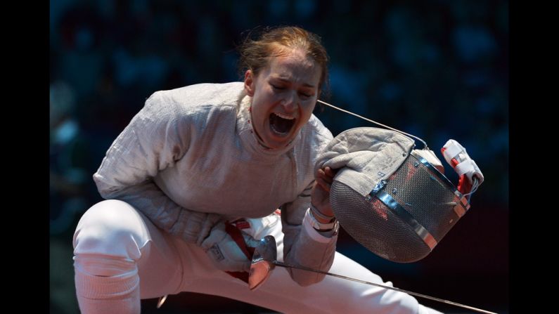 Russia's Sofya Velikaya celebrates her victory over U.S. fencer Dagmara Wozniak during their women's saber quarterfinal bout.
