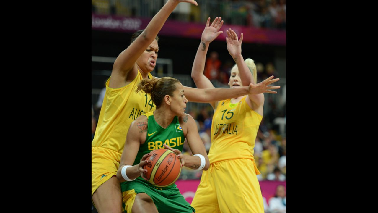 Brazil's Erika Souza, center, vies with Australia's Lauren Jackson, right, and Elizabeth Cambage during a  women's preliminary basketball match.
