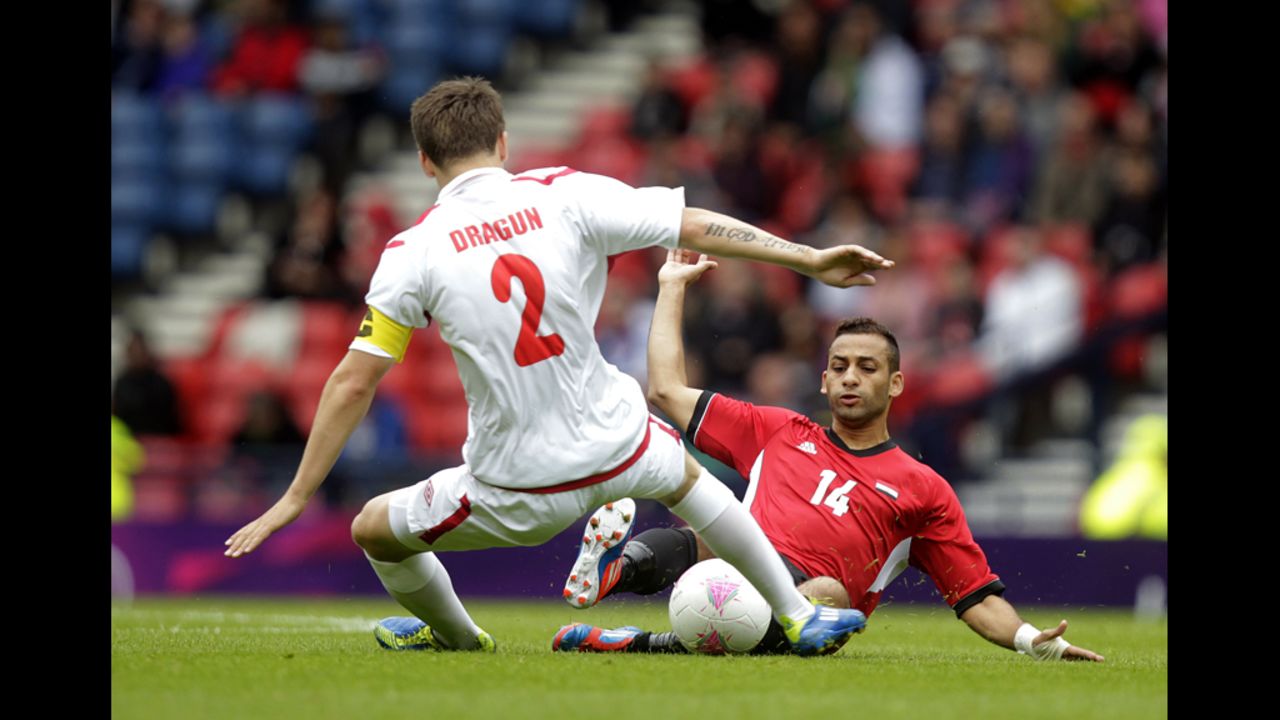 Egypt's Hossam Hassan, right, competes with Belarus' Stanislav Dragun during the men's soccer match in Glasgow, Scotland.