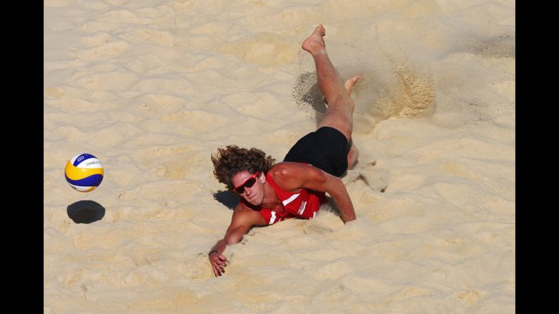 Aleksandrs Samoilovs of Latvia dives for the ball during a men's beach volleyball preliminary match against the United States.
