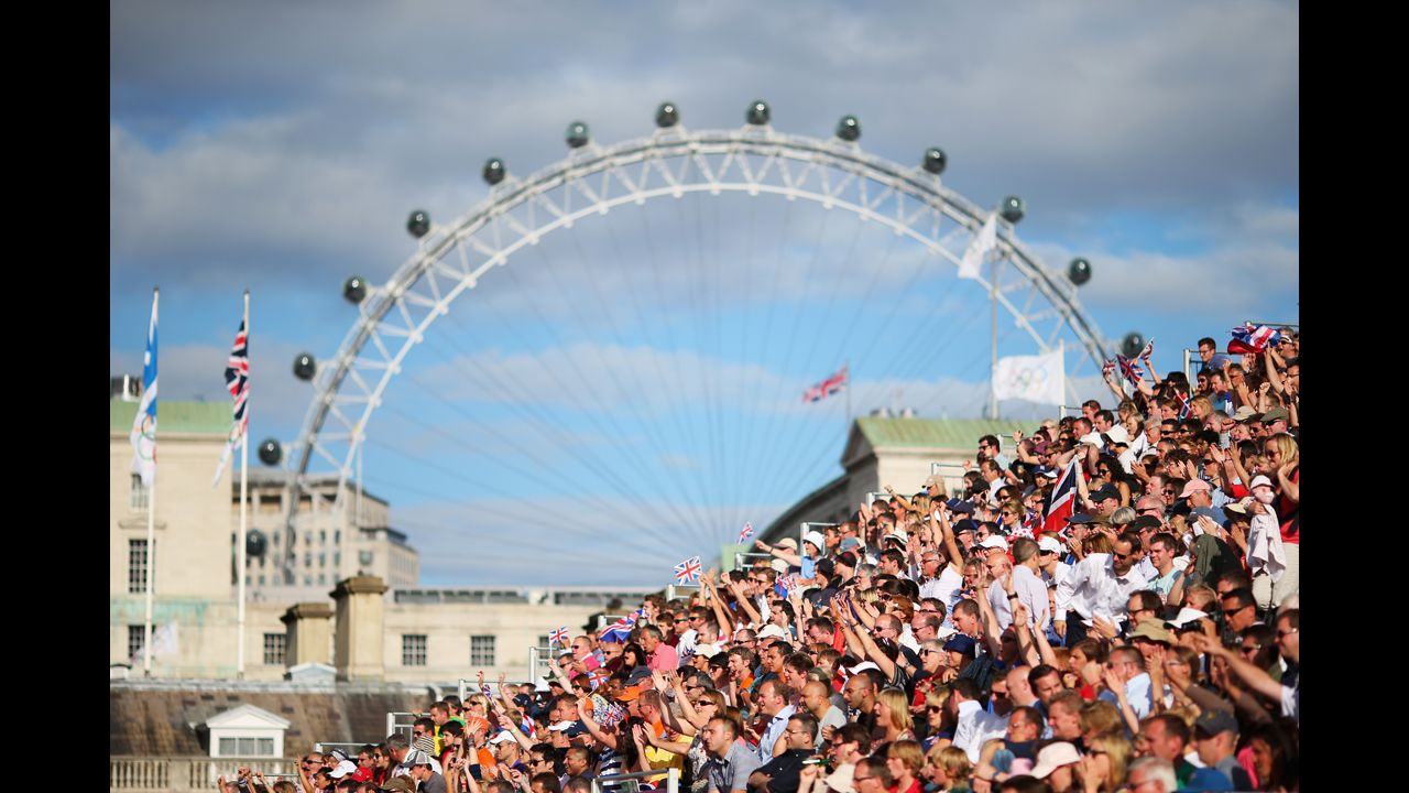 The London Eye peers down on the men's beach volleyball preliminary match between Great Britain and Norway.