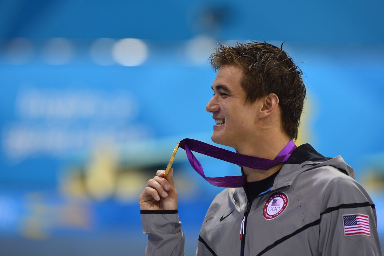 U.S. gold medalist Nathan Adrian poses on the podium after the men's 100-meter freestyle swimming event on Wednesday.