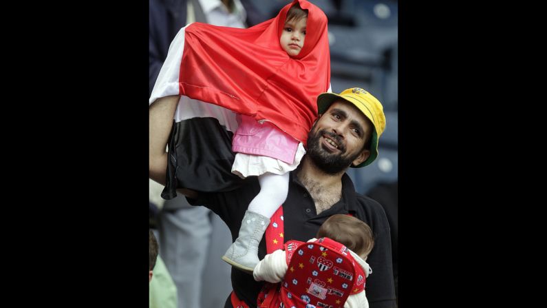 A supporter of Egypt waves a flag from the stands during the men's soccer match with Belarus.