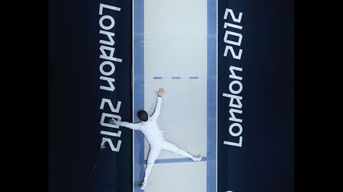 Jinsun Jung of South Korea celebrates his victory in the men's epee individual fencing bronze medal match against Seth Kelsey of the United States.