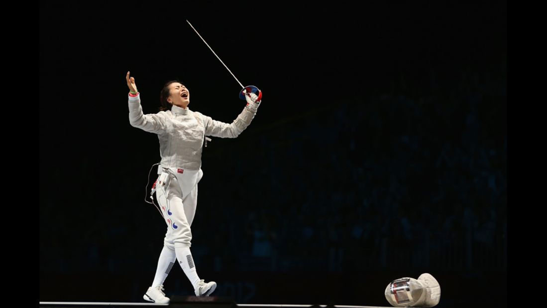South Korea's Jiyeon Kim celebrates her victory over Sofya Velikaya of Russia in the individual saber finals of women's fencing.