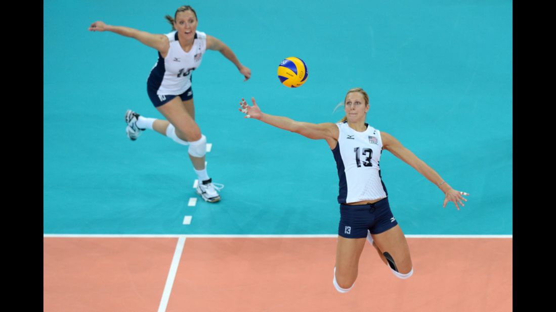 U.S. middle blocker Christa Harmotto, right, spikes during the women's preliminary volleyball match against China.