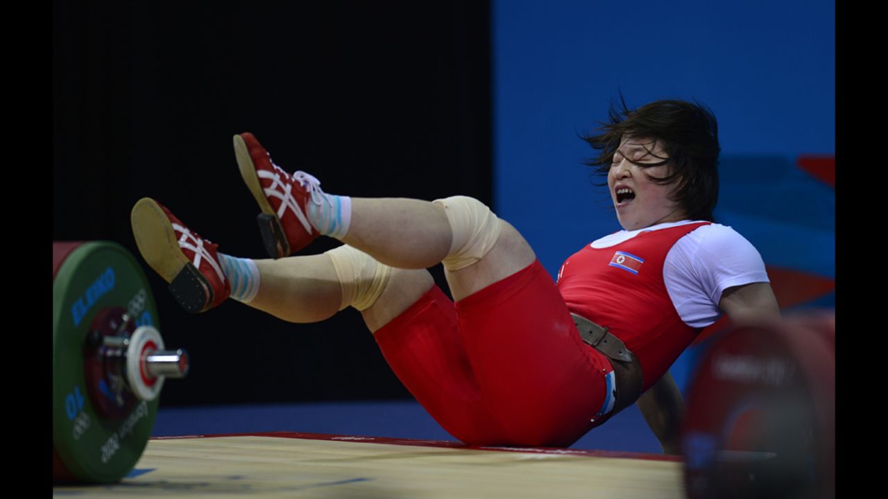 North Korea's Rim Jong Sim falls while competing in women's 69-kilogram weightlifting.