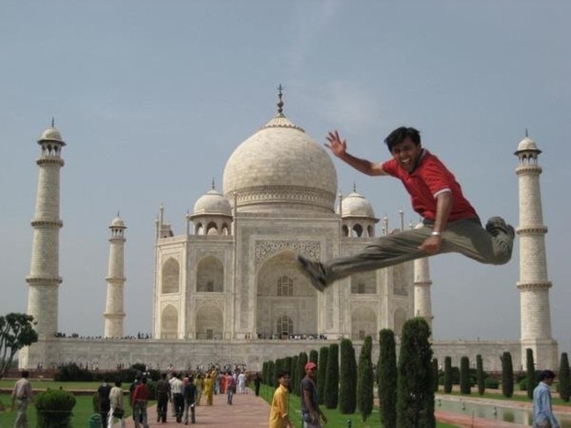 Thomas convinced someone to take a picture of him doing a flying kick in front of the Taj Mahal in India.