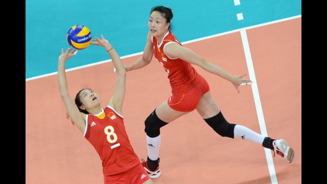 China's Wei Quiyue, left, makes a set shot during a Pool B women's volleyball preliminary match against the United States.