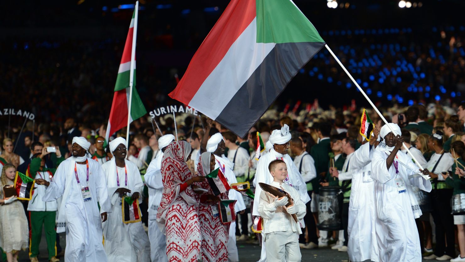 Sudan's team parades. Frida Ghitis says coverage of the Games overlooks fascinating stories of athletes from other nations.
