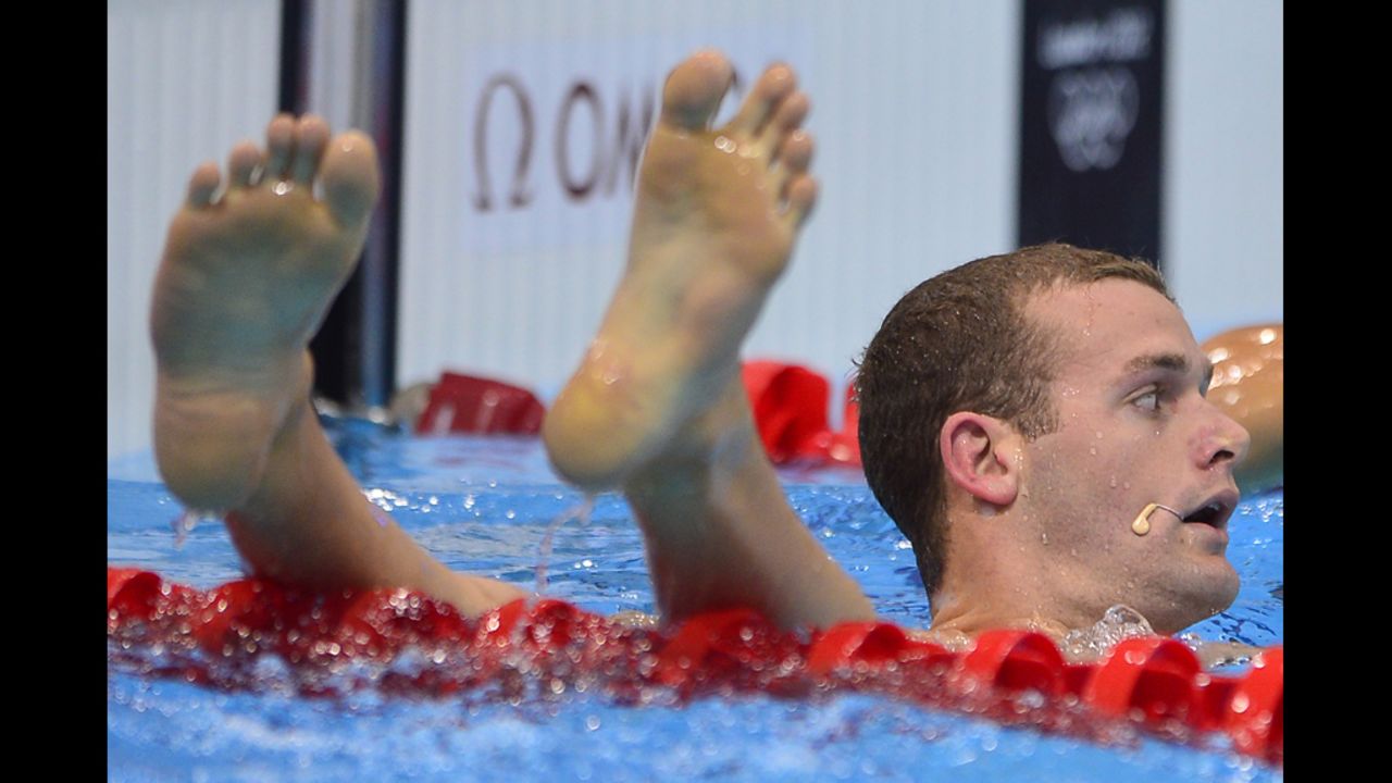 U.S. swimmer Tyler Clary awaits assistance to reassemble his limbs.