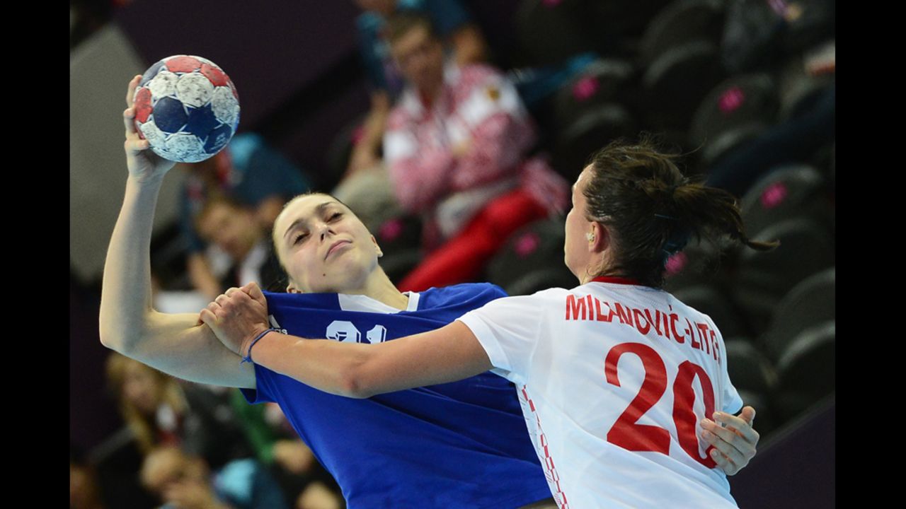 Russia's left back Victoria Zhilinskayte, left, vies with Croatia's pivot Vesna Milanovic-Litre during the women's preliminaries group B handball match.