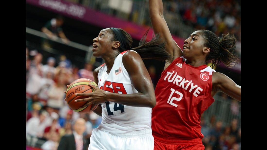 Center for the United States Tina Charles, left, vies with Turkey's Kuanitra Hollingsvorth during the women's preliminary round basketball match.