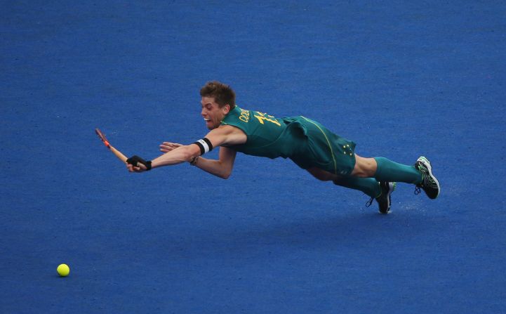 Captain Edward Ockenden of Australia dives for the ball during the men's preliminary field hockey match against Spain on Wednesday.