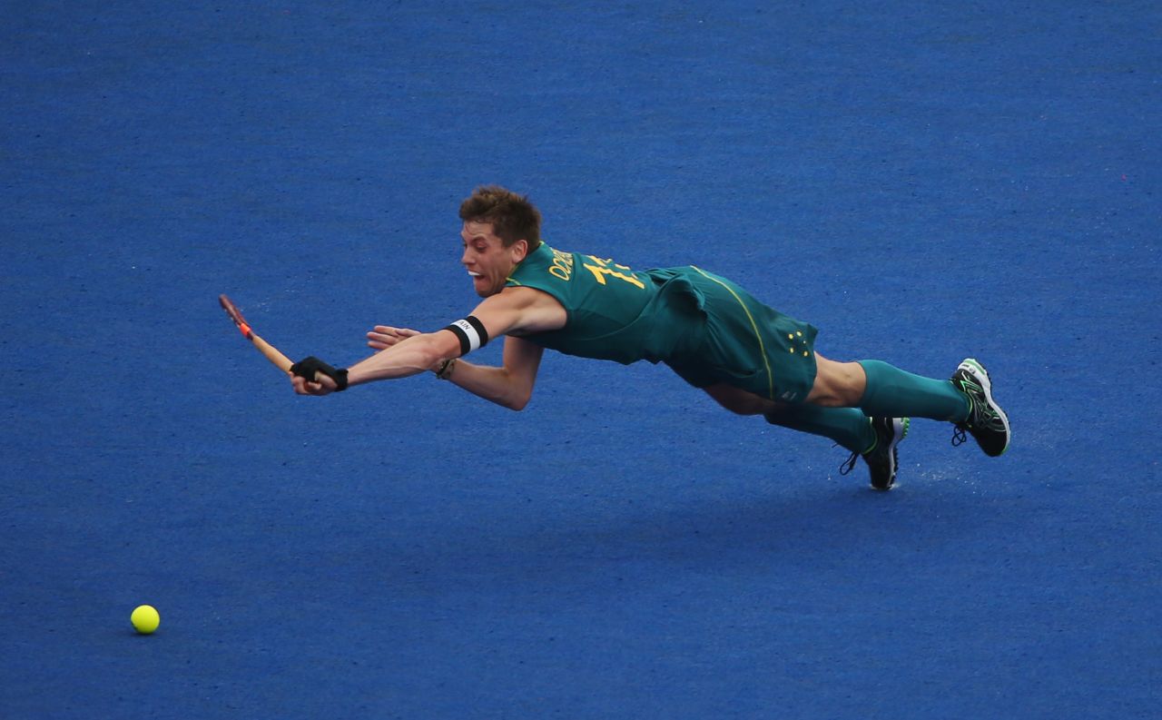 Captain Edward Ockenden of Australia dives for the ball during the men's preliminary field hockey match against Spain on Wednesday.