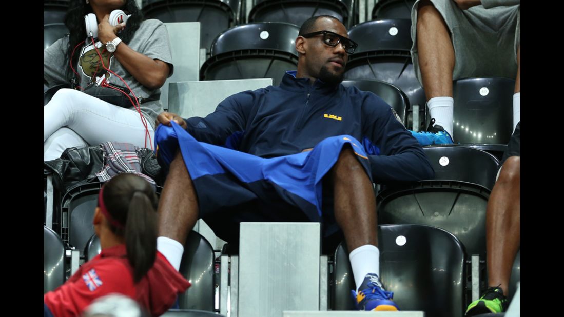 United States men's basketball player LeBron James watches the women's basketball preliminary round match between the United States and Turkey.