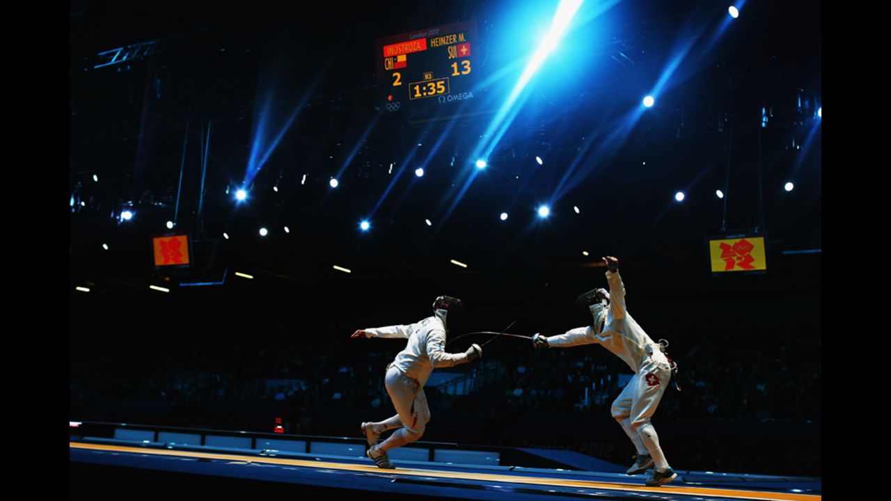 Paris A. Inostroza Budinich of Chile competes against Max Heinzer of Switzerland in the men's individual epee fencing round of 32 on Wednesday.