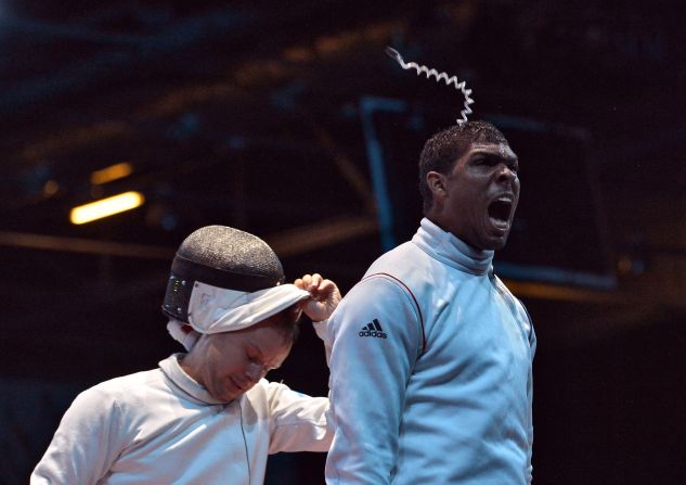 France's Yannick Borel, right, celebrates his victory over Ukraine's Dmitriy Karuchenko at the end of their men's epee fencing bout Wednesday.