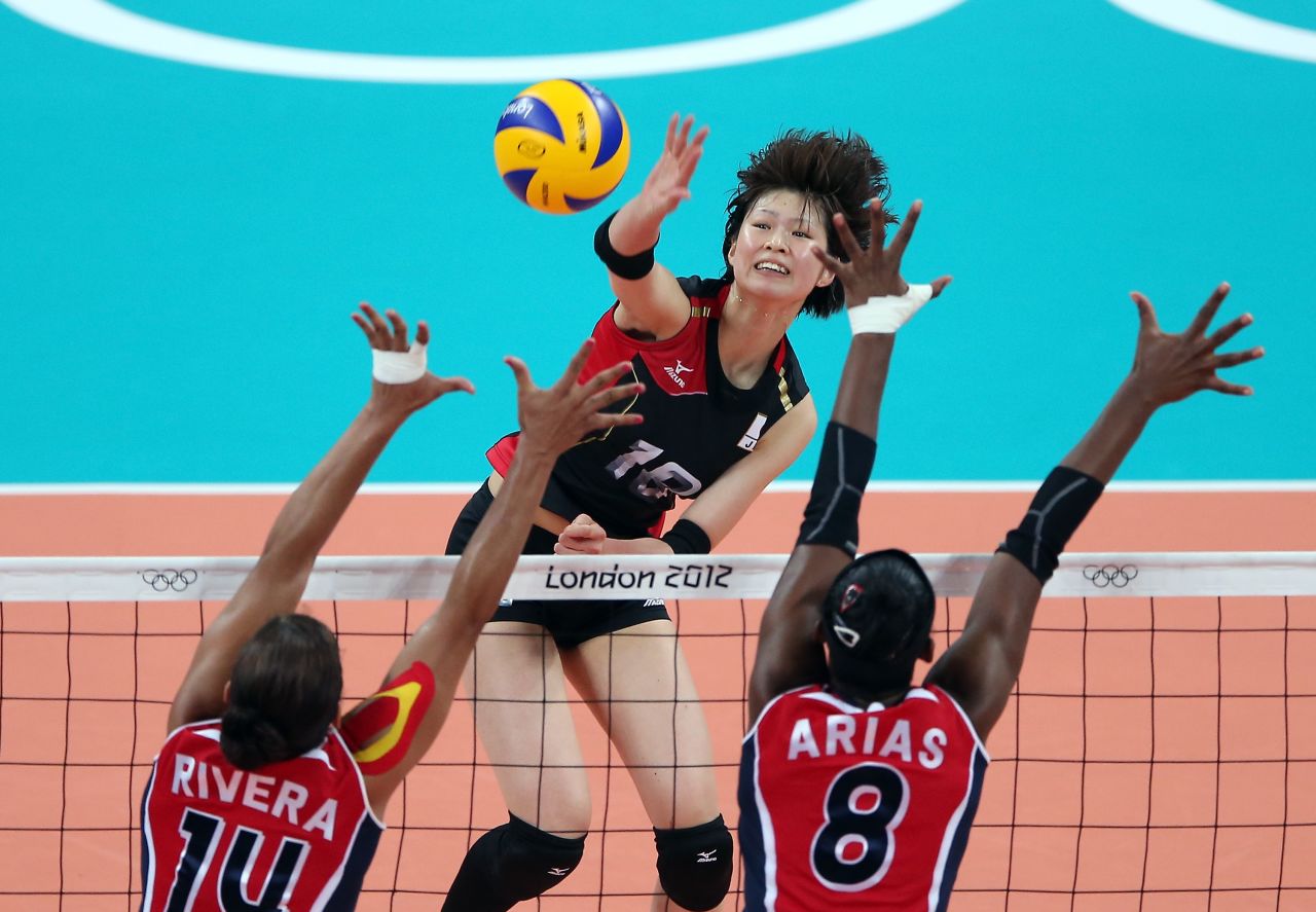 Saori Kimura of Japan spikes the volleyball Wednesday as Prisilla Altagracia Rivera Brens, left, and Candida Estefany Arias Perez of the Dominican Republic try to block.