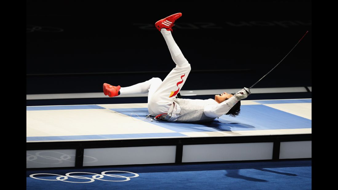 Sheng Lei of China celebrates winning the men's foil individual gold medal bout against Alaaeldin Abouelkassem of Egypt.