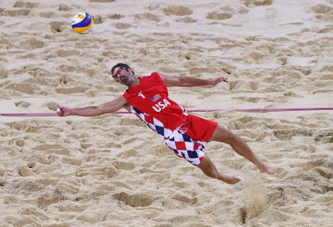 Todd Rogers of United States dives for a shot during the men's beach volleyball preliminary match against Spain.