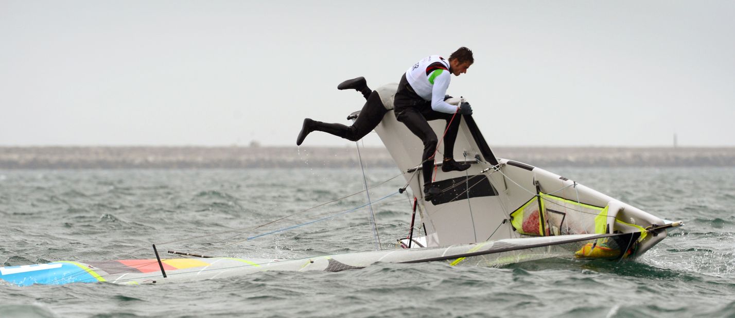 Germany's Hannes Baumann and Tobias Schadewaldt attempt to right their skiff in the 49er sailing class in Weymouth, England.